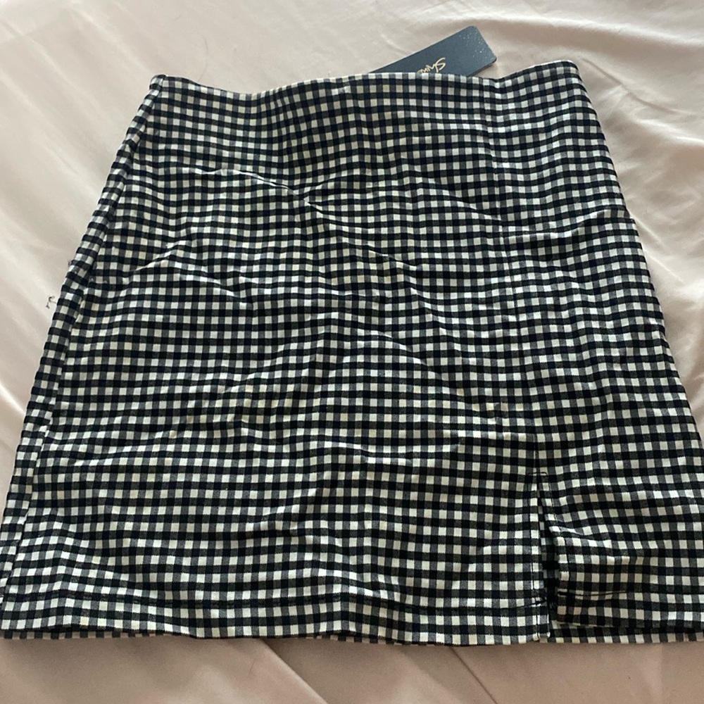Size Medium, Shinestar, black and white checkered skirt with slit new with tags.